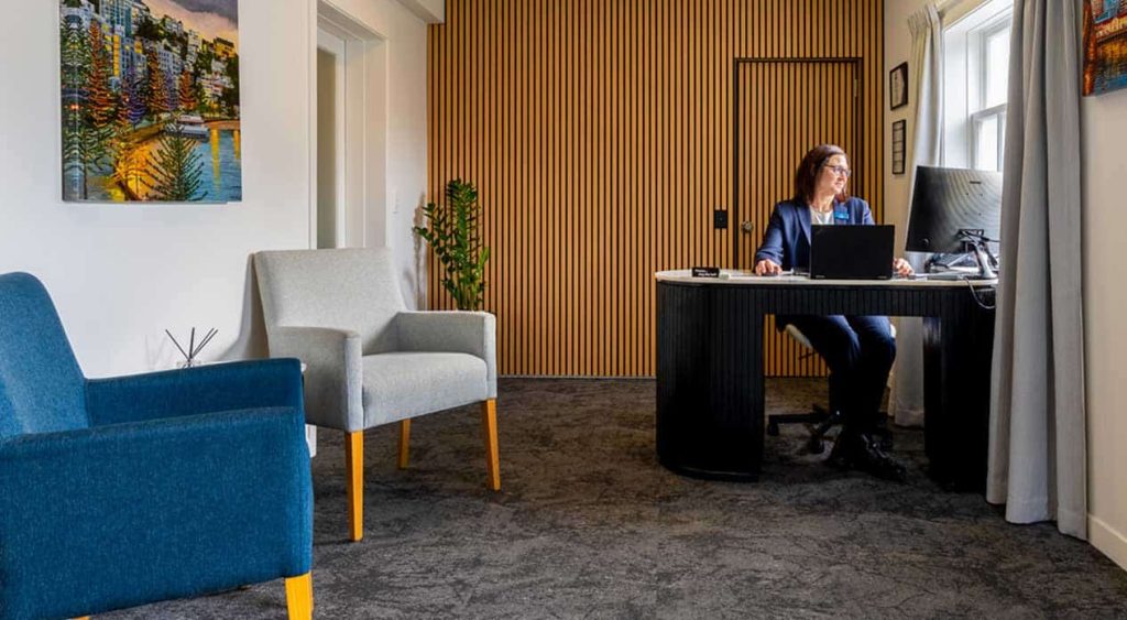 A Lychgate funeral director at her desk in the Willis Street office